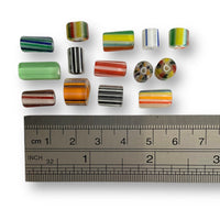 Glass beads, tubular in shape. Assorted sizes and colours. Made in India.