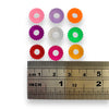 Corrugated plastic ring bead, measuring 10.5mm in diameter.