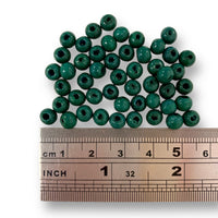 6mm wooden beads in Green. Sold in packs of 100 pieces, and available in a multi coloured or single colour packs. Craftworkz 6mm wooden beads have a hole size of approximately 2mm. Some slight variation in size is normal.