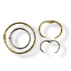 Four sizes of hinged rings in gold and silver, on a white background.