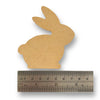 A MDF blank sitting bunny shape with a ruler on a white background.