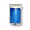 A small container of royal blue glitter on a white background
