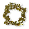 A wired star garland made up of gold colored star-shaped elements coiled into a circle on a white background.