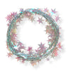 A wired star garland made up of opalescent colored star-shaped elements coiled into a circle on a white background.