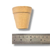 Small paper Mache half pot with a ruler for scale on a white background