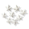 Seven small white polystyrene star shapes arranged on a plain white background.