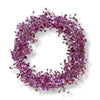 A wired star garland made up of pale pink colored star-shaped elements coiled into a circle on a white background.
