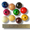 Colorful wooden beads with a ruler for scale on a white background