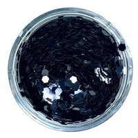 A clear container filled with black hexagonal chunky glitter.