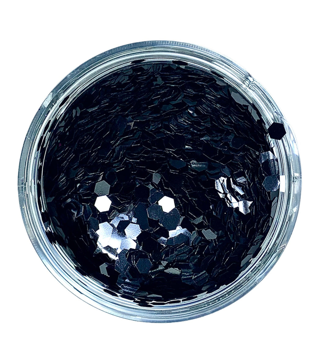 A clear container filled with black hexagonal chunky glitter.