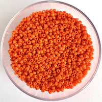 Craftworkz size 10/0 approx. 2mm glass seed beads in opaque orange. Available in over 30 colours.