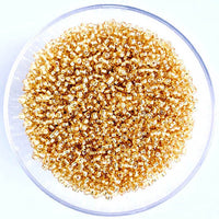 Craftworkz size 10/0 approx. 2mm glass seed beads in transparent gold. Available in over 30 colours.