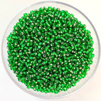Craftworkz size 10/0 approx. 2mm glass seed beads in transparent green. Available in over 30 colours.