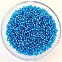 Craftworkz size 10/0 approx. 2mm glass seed beads in transparent light blue. Available in over 30 colours.