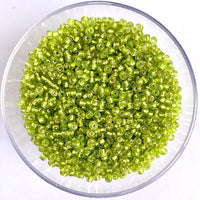 Craftworkz size 10/0 approx. 2mm glass seed beads in transparent light green. Available in over 30 colours.