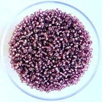 Craftworkz size 10/0 approx. 2mm glass seed beads in transparent plum. Available in over 30 colours.