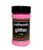 A shaker jar containing pink ultra fine opalescent glitter, with the brand label 'craftworkz glitter 113g' on the lid.